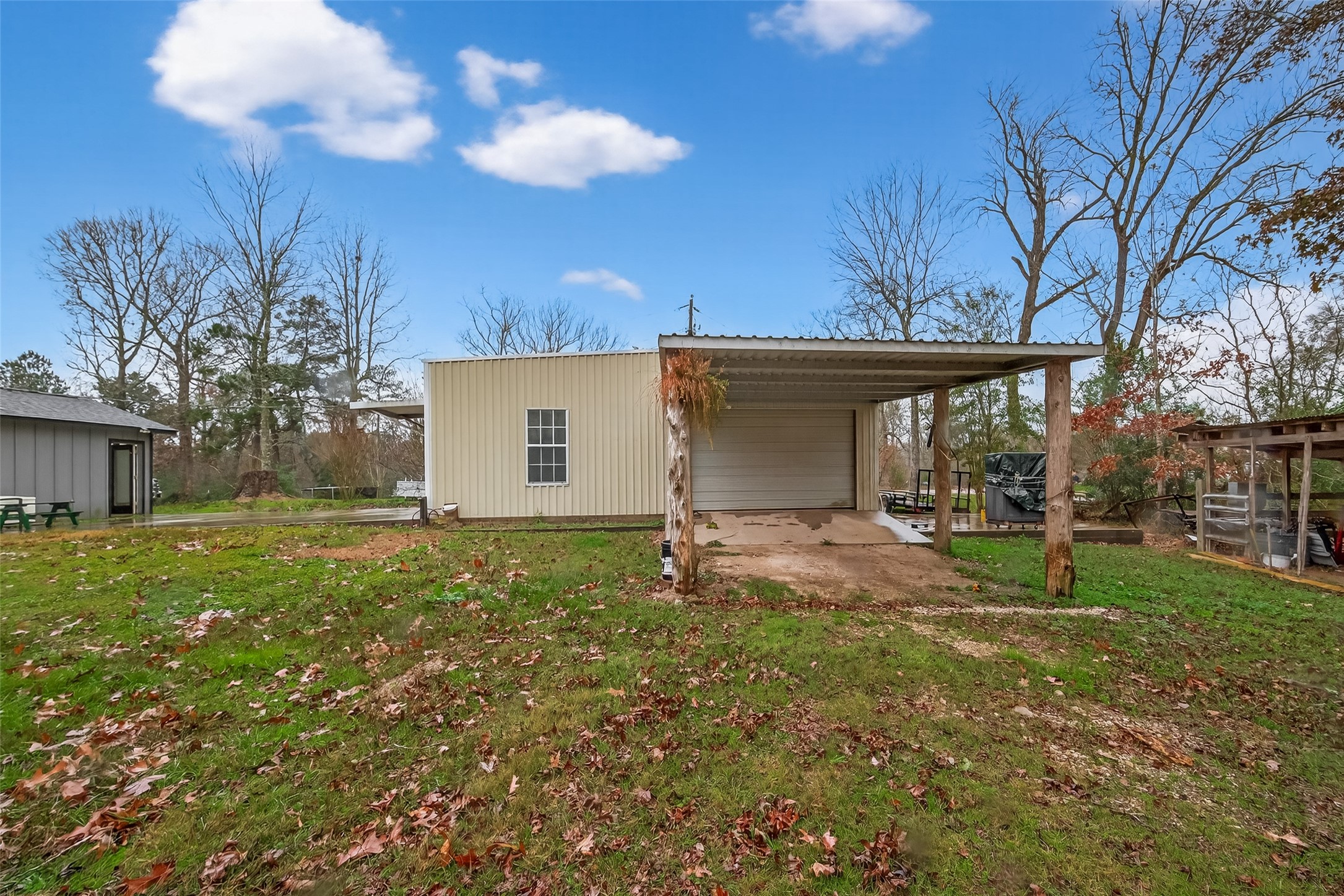 588 County Road 2307 Cleveland, TX 77327 - Photo 24 of 24 a view of a house with backyard and a tree