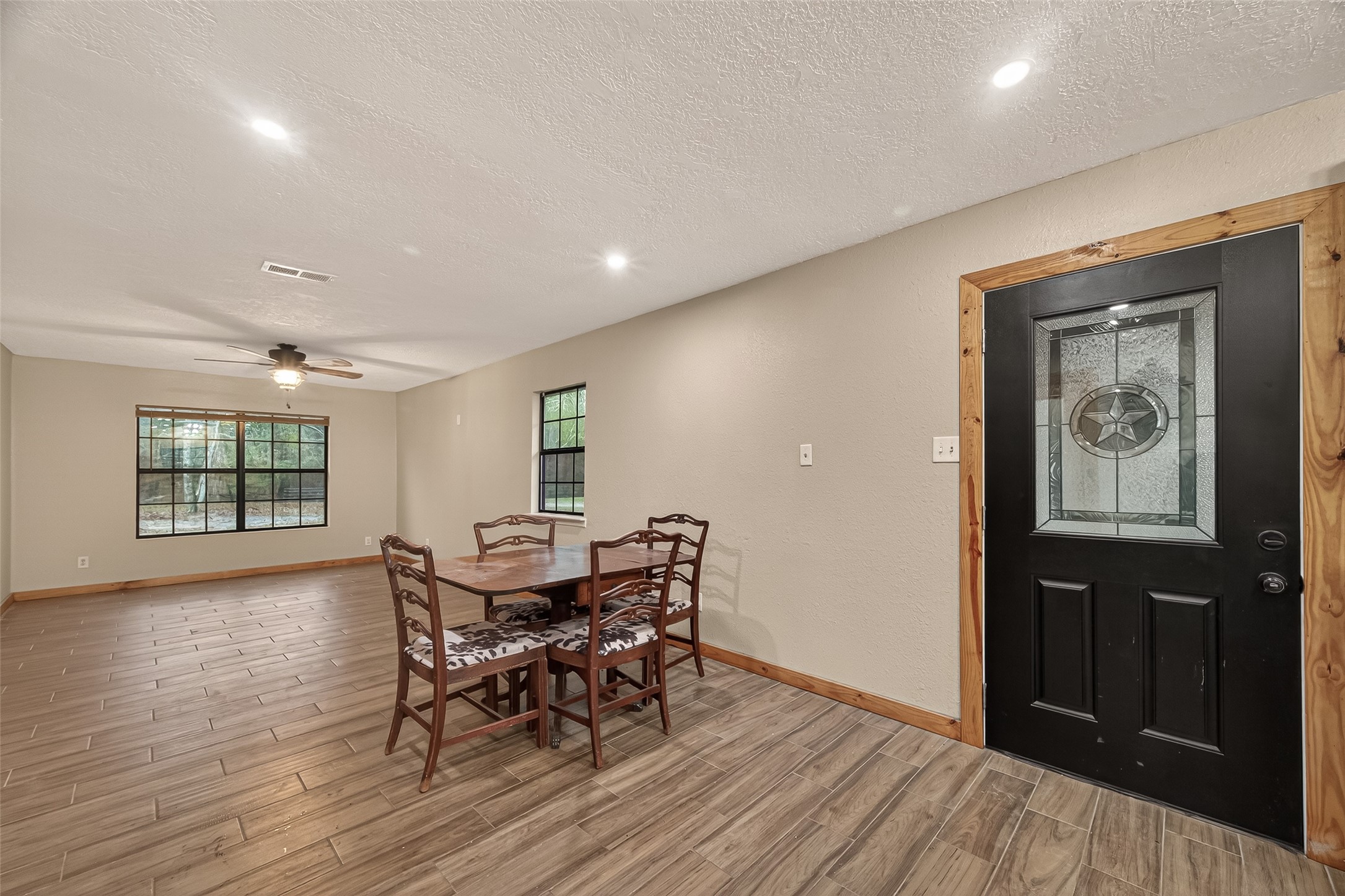 588 County Road 2307 Cleveland, TX 77327 - Photo 3 of 24 a view of a dining room with furniture and wooden floor