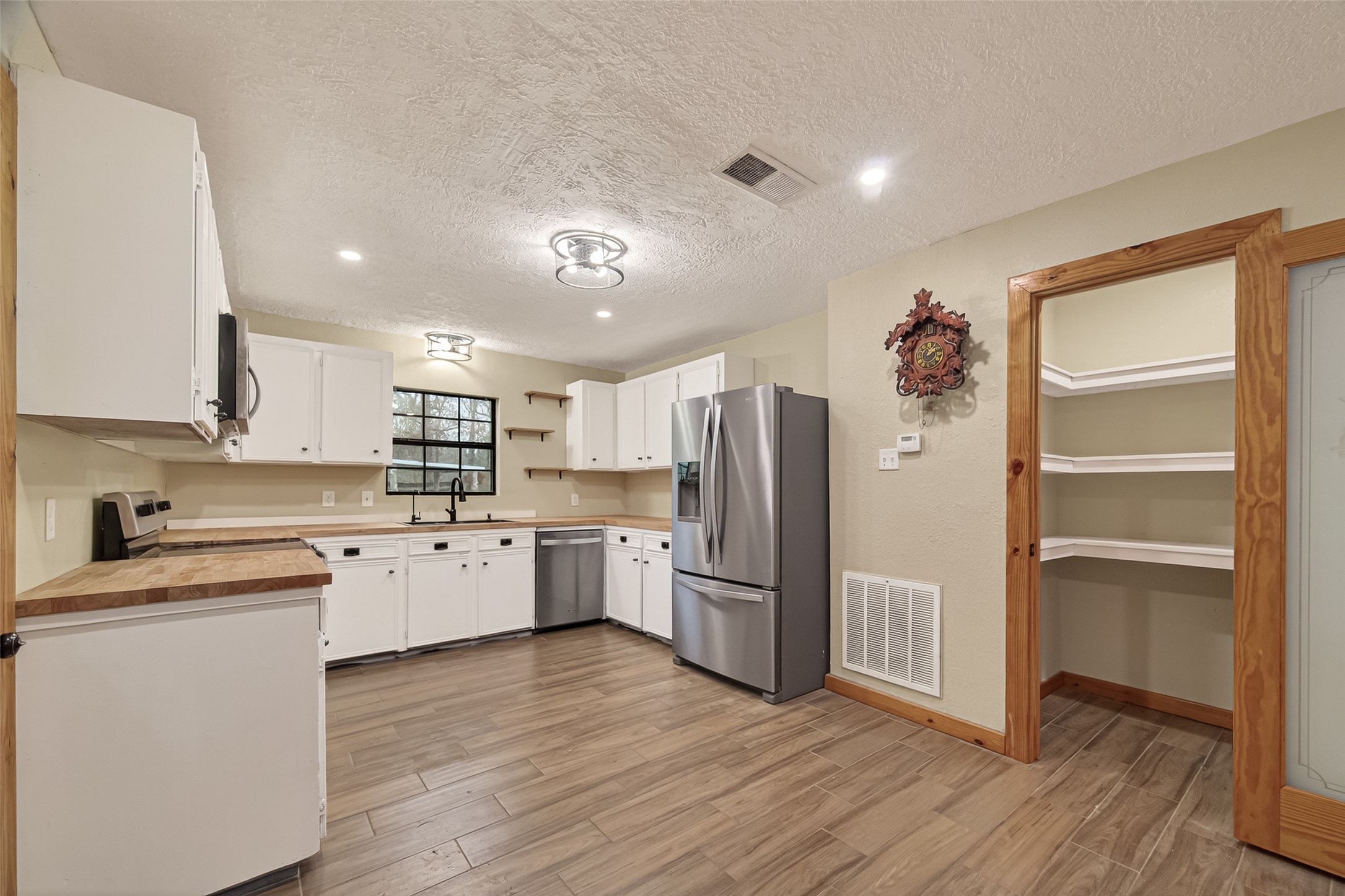 588 County Road 2307 Cleveland, TX 77327 - Photo 6 of 24 a kitchen with a refrigerator and a sink