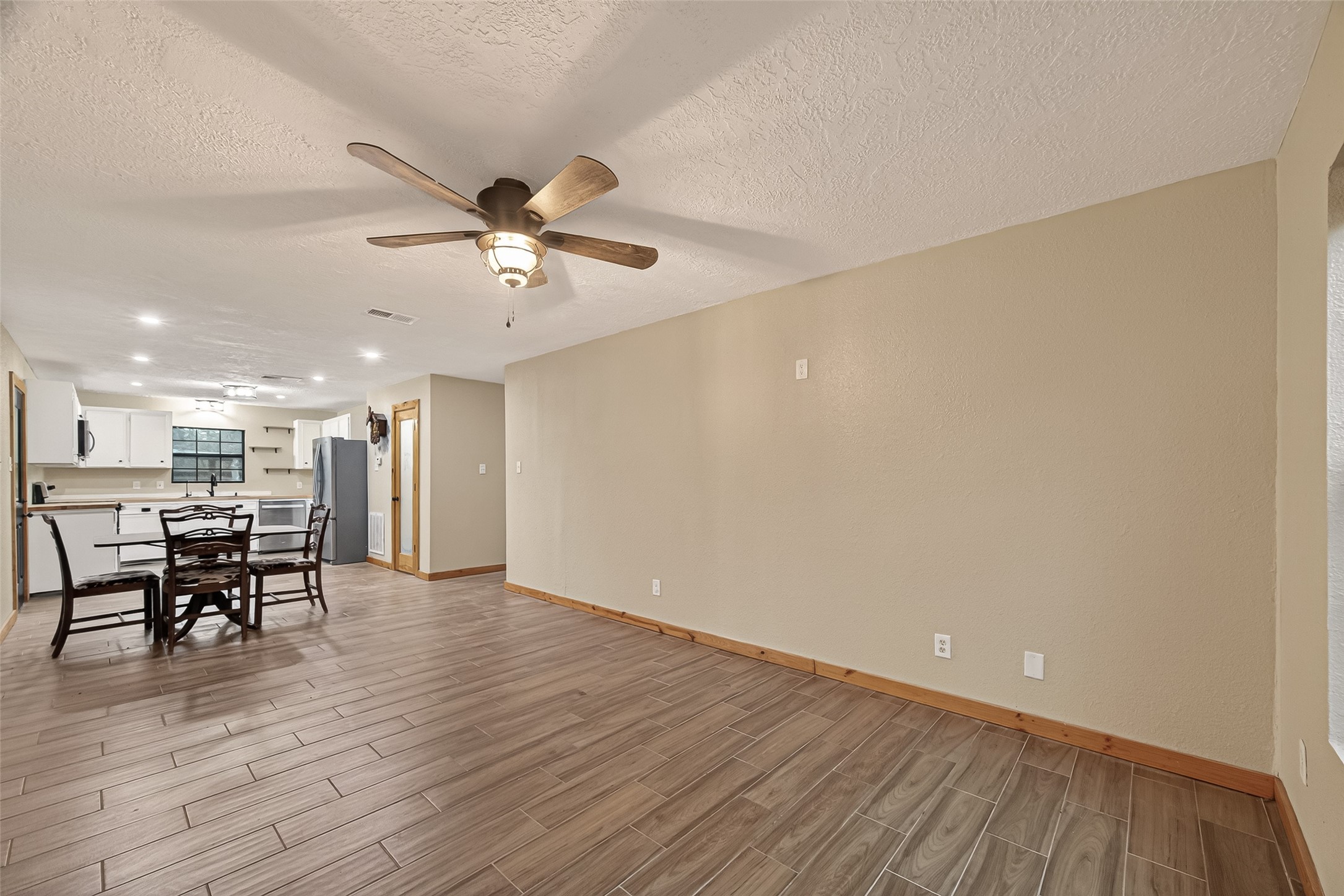 588 County Road 2307 Cleveland, TX 77327 - Photo 8 of 24 a view of a workspace with wooden floor