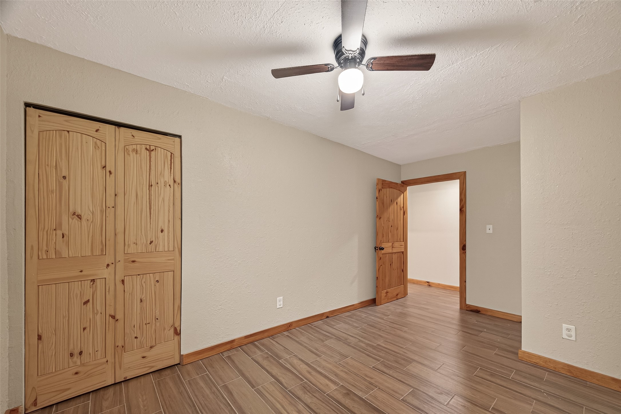 588 County Road 2307 Cleveland, TX 77327 - Photo 10 of 24 an empty room with wooden floor cabinet and windows