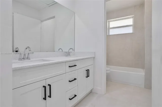 a bathroom with a sink double vanity and a bathtub