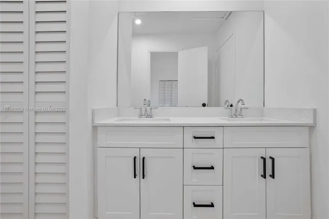 a bathroom with a sink vanity and a mirror