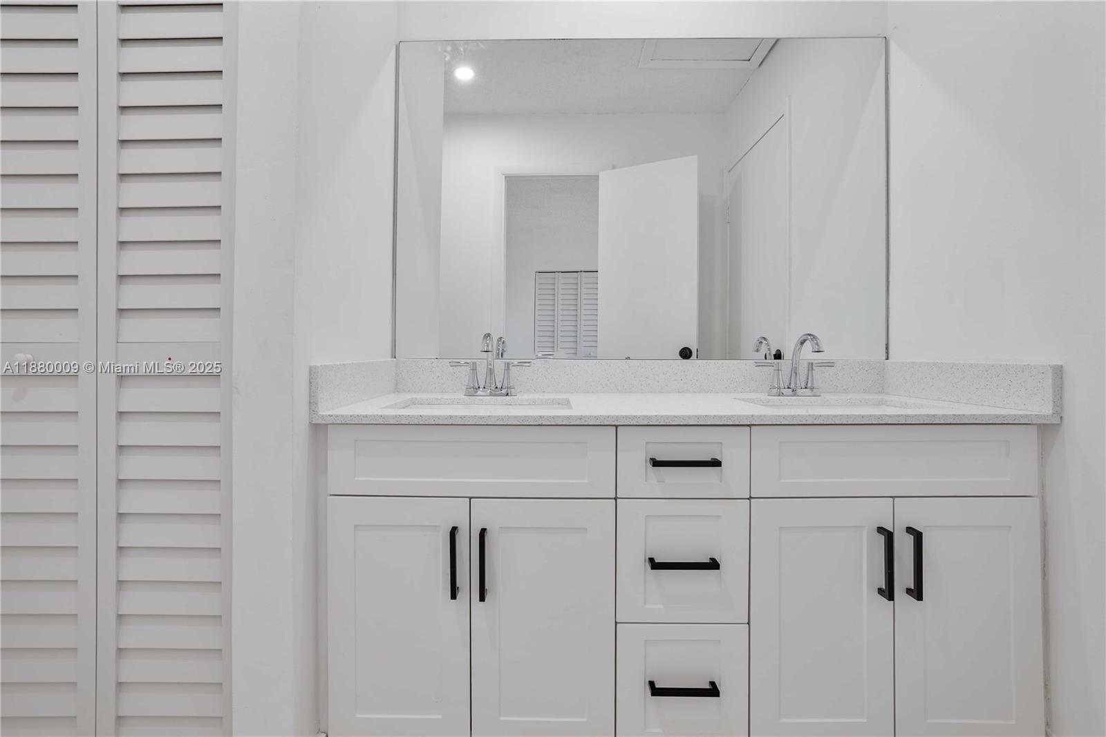 3524 Northwest 4th Terrace, Unit 1 Miami, FL 33125 - Photo 21 of 35 a bathroom with a sink vanity and a mirror