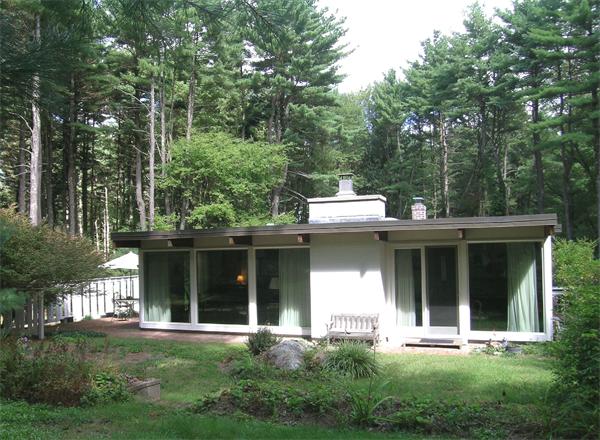 34 Conant Road Lincoln, MA 01773 - Photo 1 of 1 a view of a white house with a large window and a yard with plants and large trees