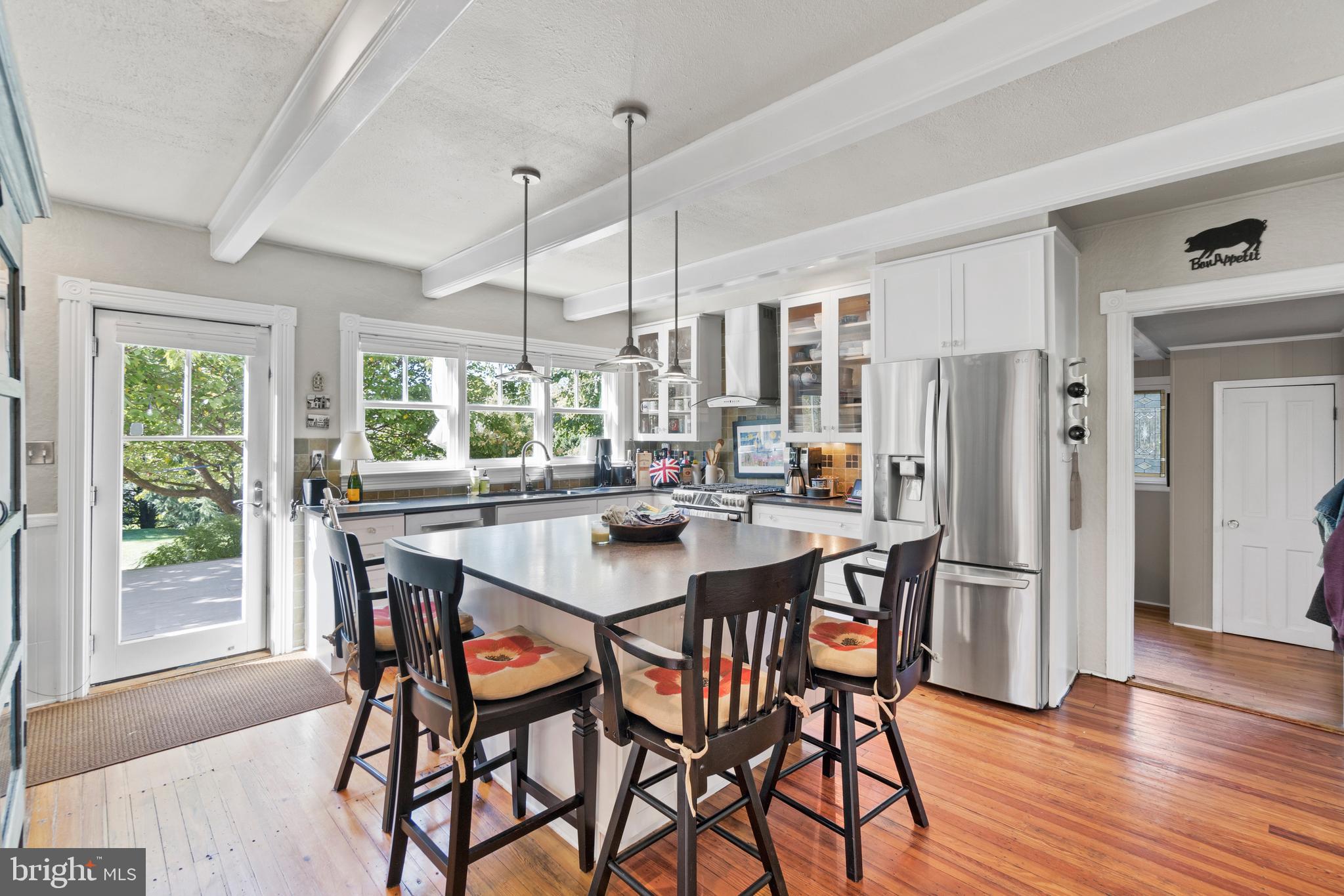 1005 Grant Street Herndon, VA 20170 - Photo 19 of 59 a dining room with stainless steel appliances granite countertop a dining table chairs and a refrigerator