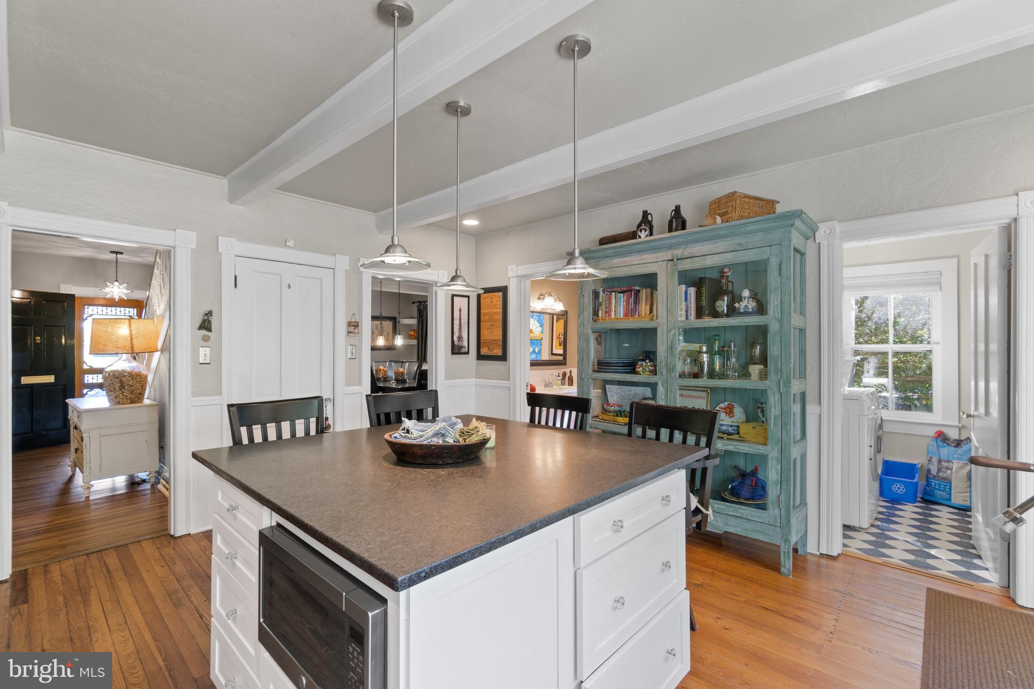 1005 Grant Street Herndon, VA 20170 - Photo 20 of 59 a kitchen with stainless steel appliances granite countertop a stove a refrigerator a sink a dining table and chairs with wooden floor