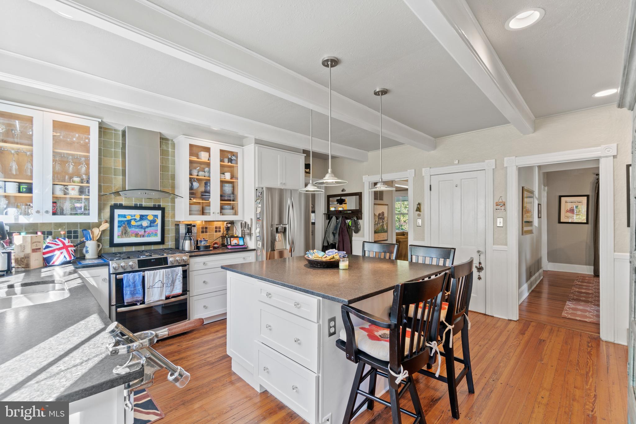 1005 Grant Street Herndon, VA 20170 - Photo 21 of 59 a kitchen with stainless steel appliances kitchen island granite countertop a table chairs and a refrigerator