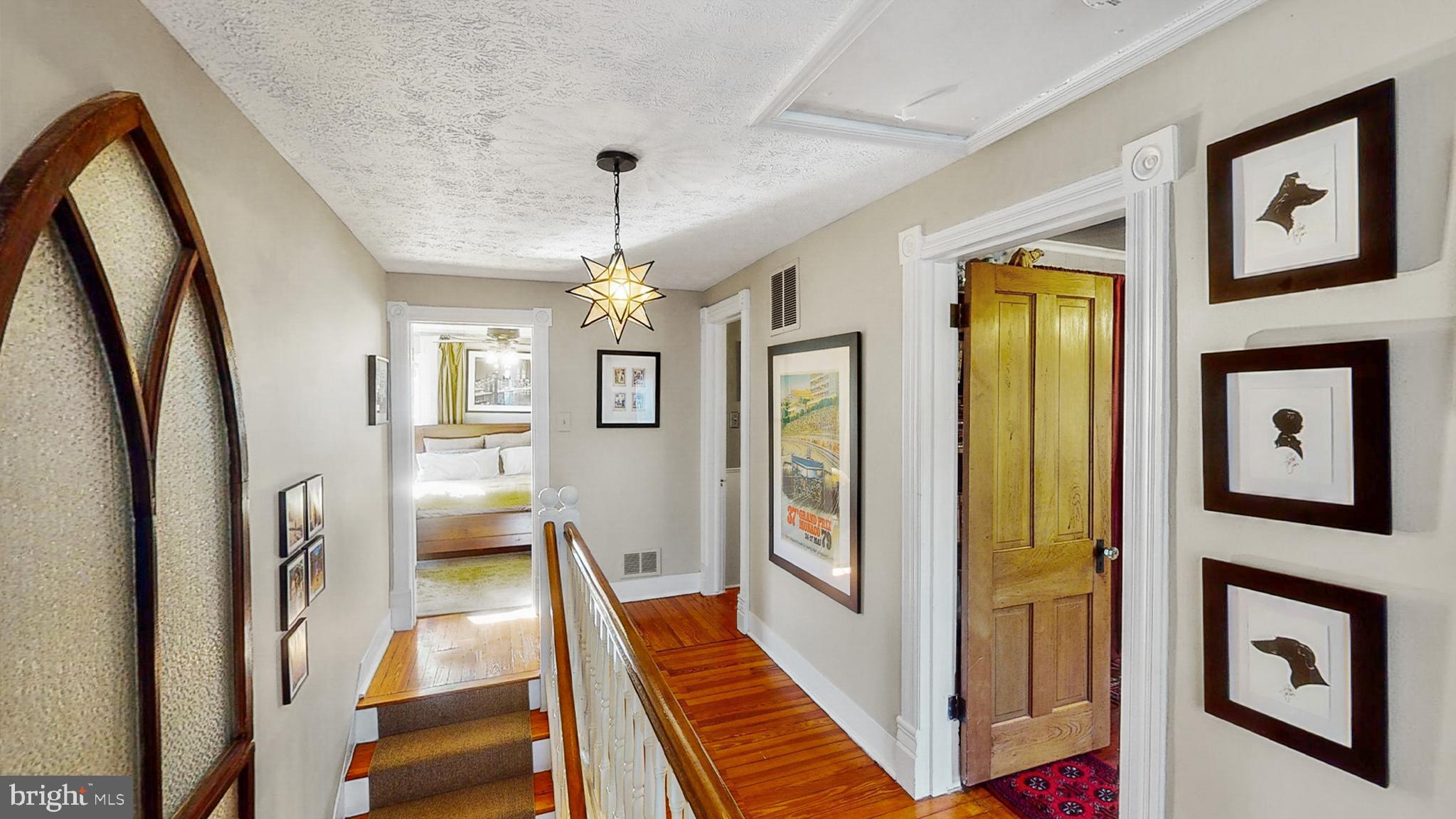 1005 Grant Street Herndon, VA 20170 - Photo 24 of 59 a view of a hallway with couches and a dining table with wooden floor