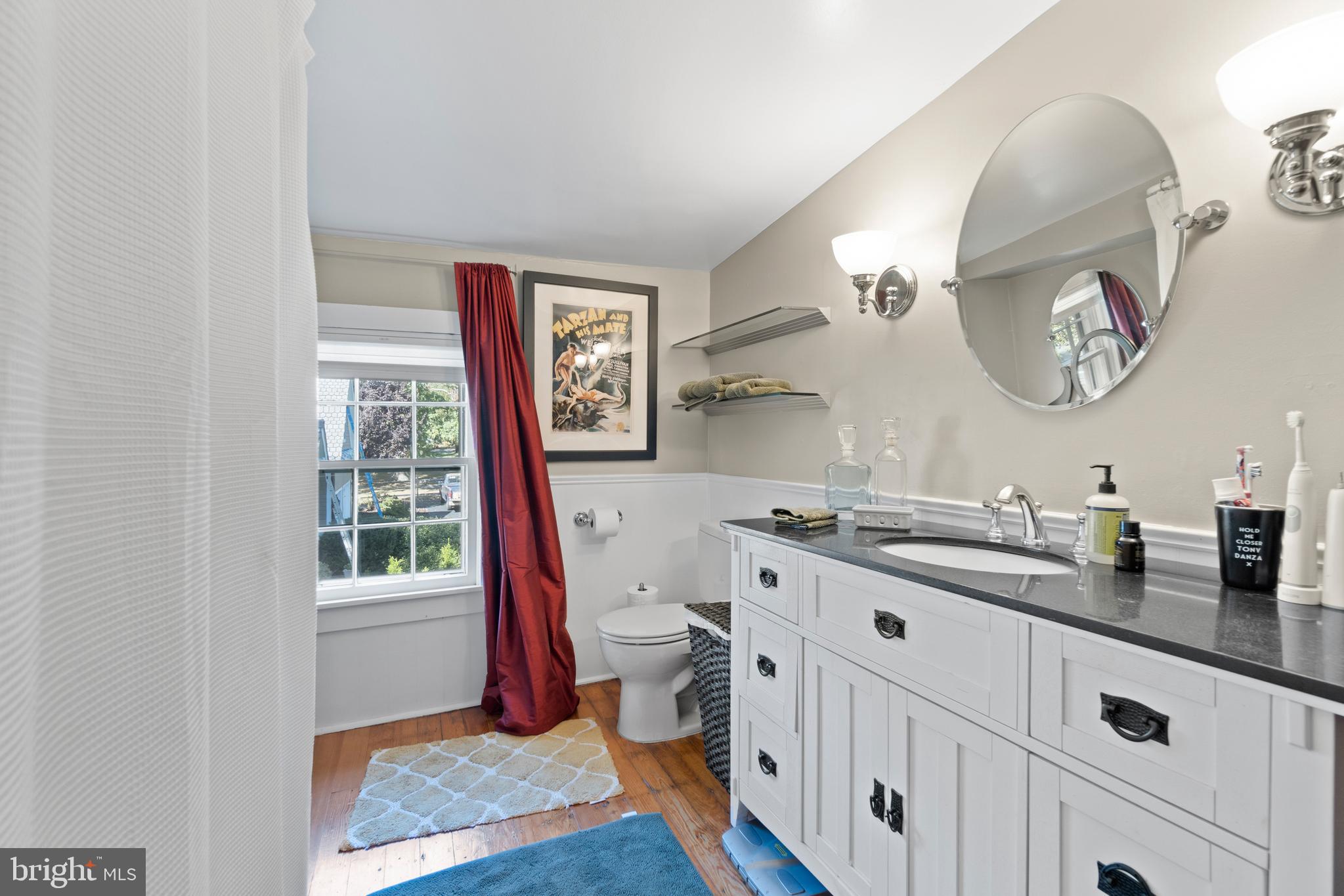 1005 Grant Street Herndon, VA 20170 - Photo 29 of 59 a bathroom with a granite countertop sink mirror vanity and toilet