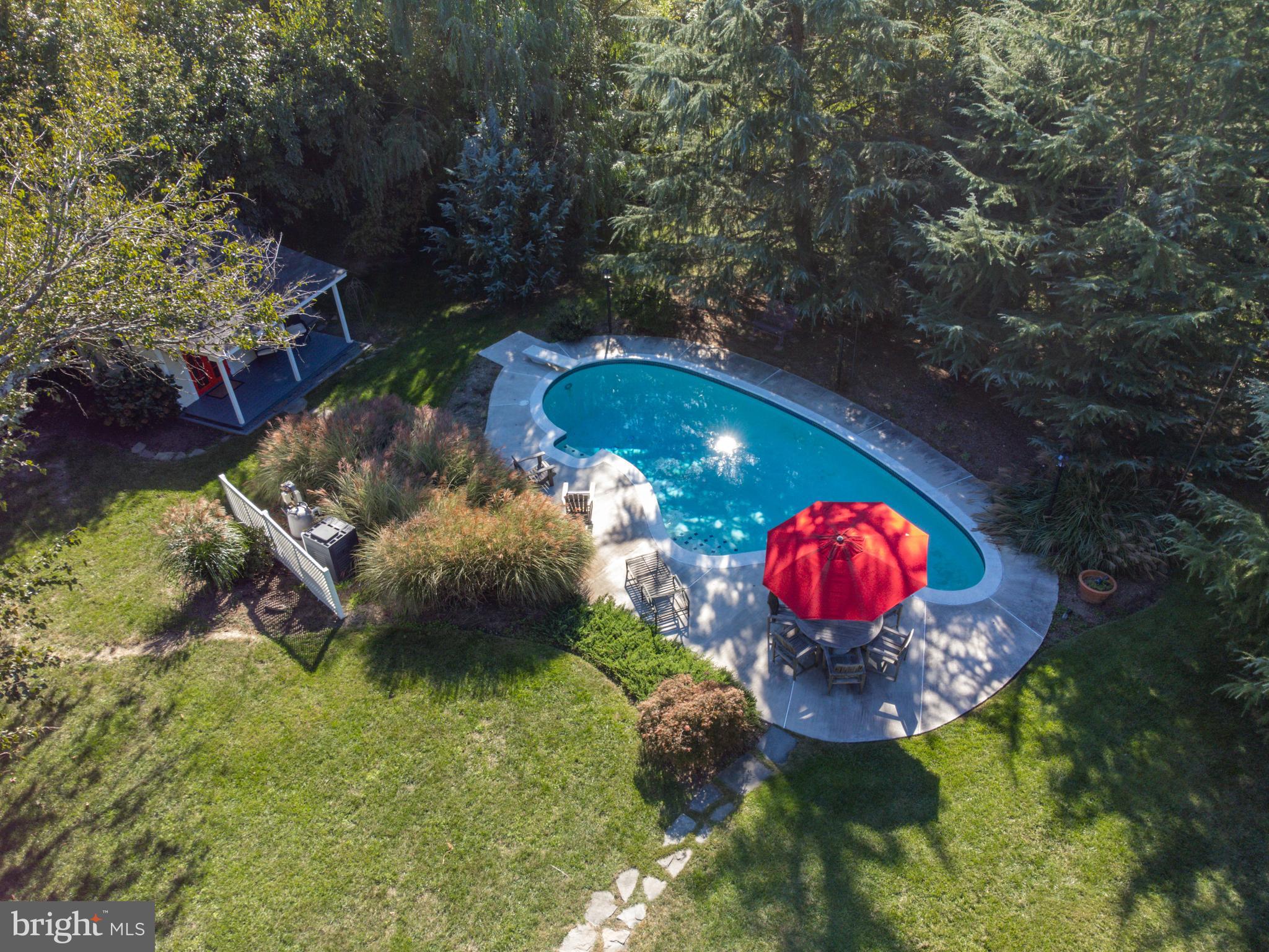 1005 Grant Street Herndon, VA 20170 - Photo 43 of 59 a view of a swimming pool with red chairs