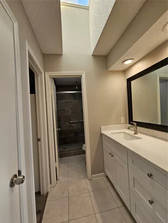 a bathroom with a double vanity sink and mirror