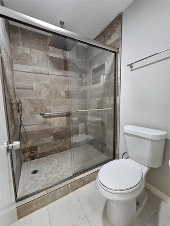 a bathroom with a shower and a toilet