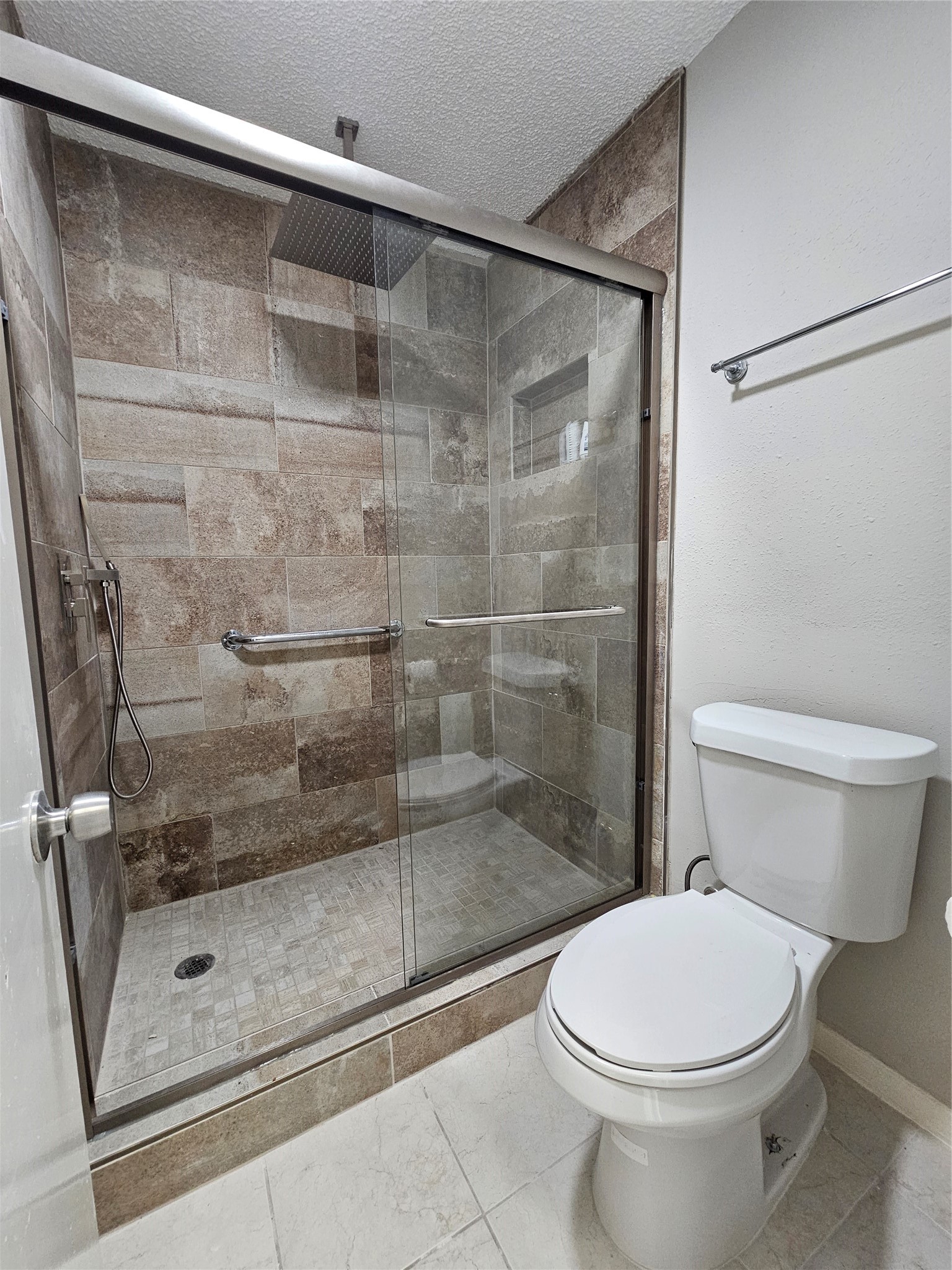 7887 Kendalia Drive Houston, TX 77036 - Photo 15 of 23 a bathroom with a shower and a toilet