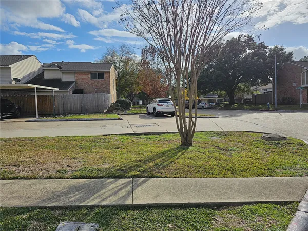 a view of a yard with cars