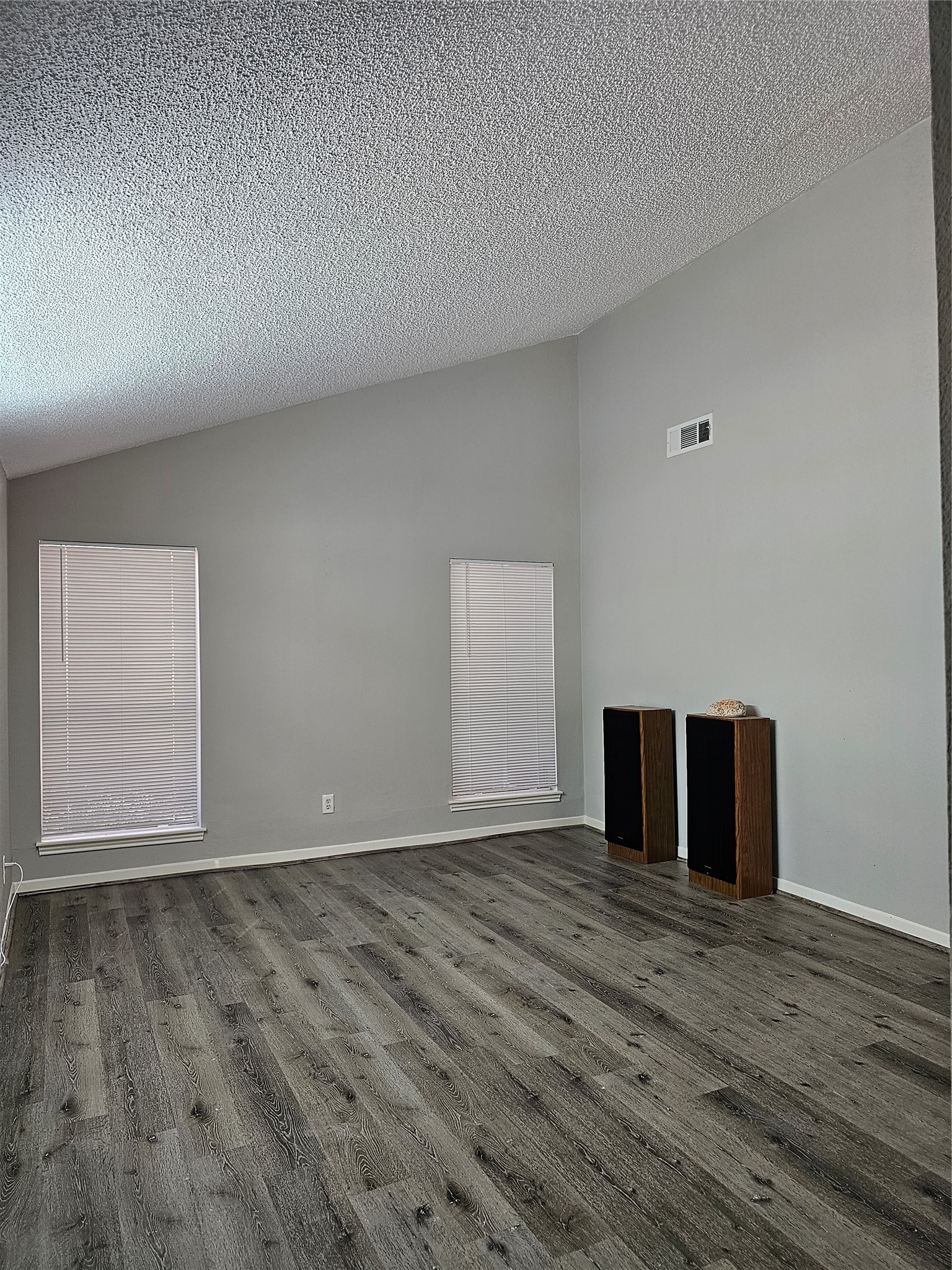 7887 Kendalia Drive Houston, TX 77036 - Photo 3 of 23 a view of an empty room with wooden floor and a window