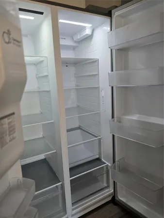 a view of walk in closet with empty racks