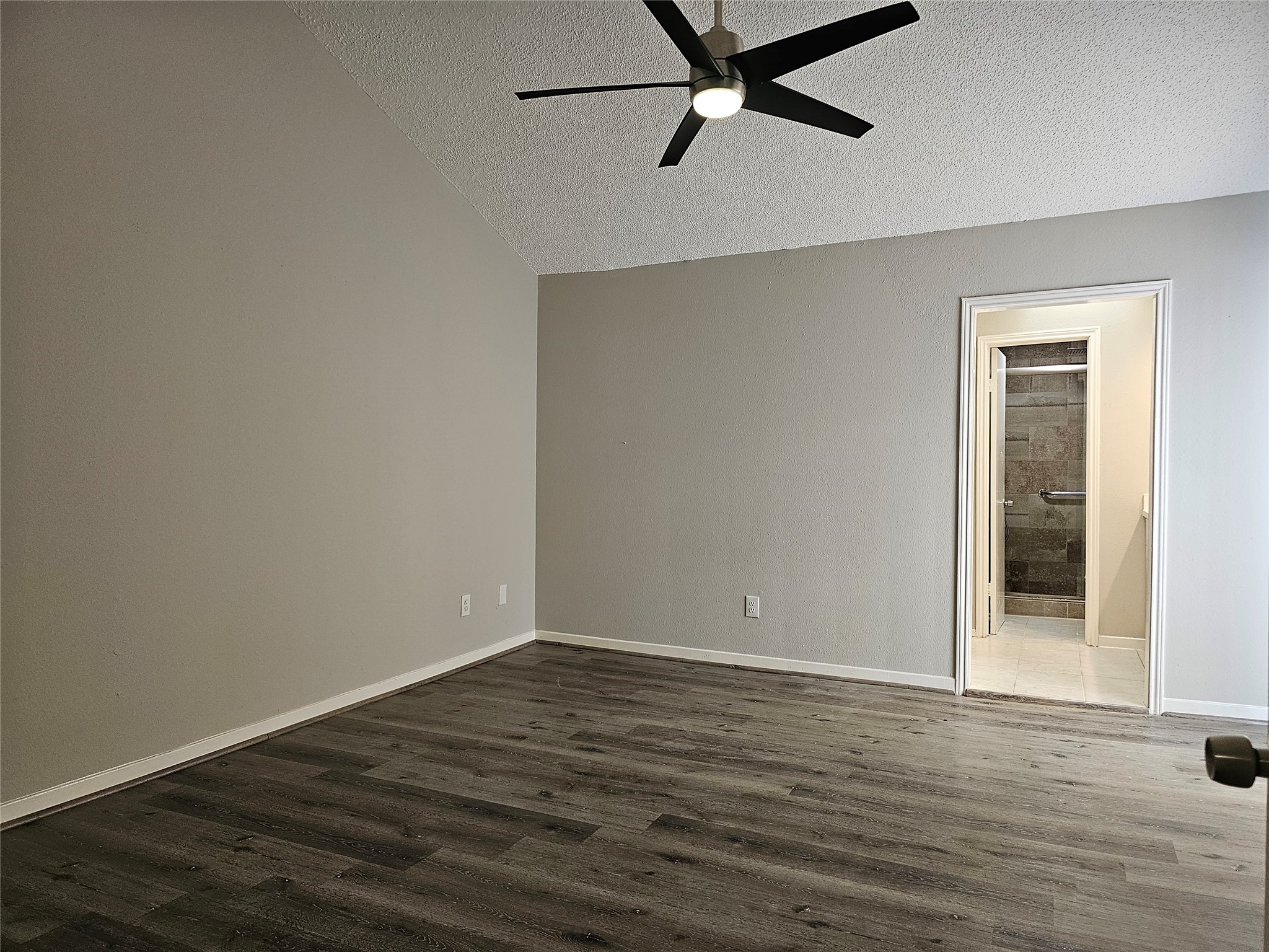 7887 Kendalia Drive Houston, TX 77036 - Photo 7 of 23 a view of a room with wooden floor and ceiling fan