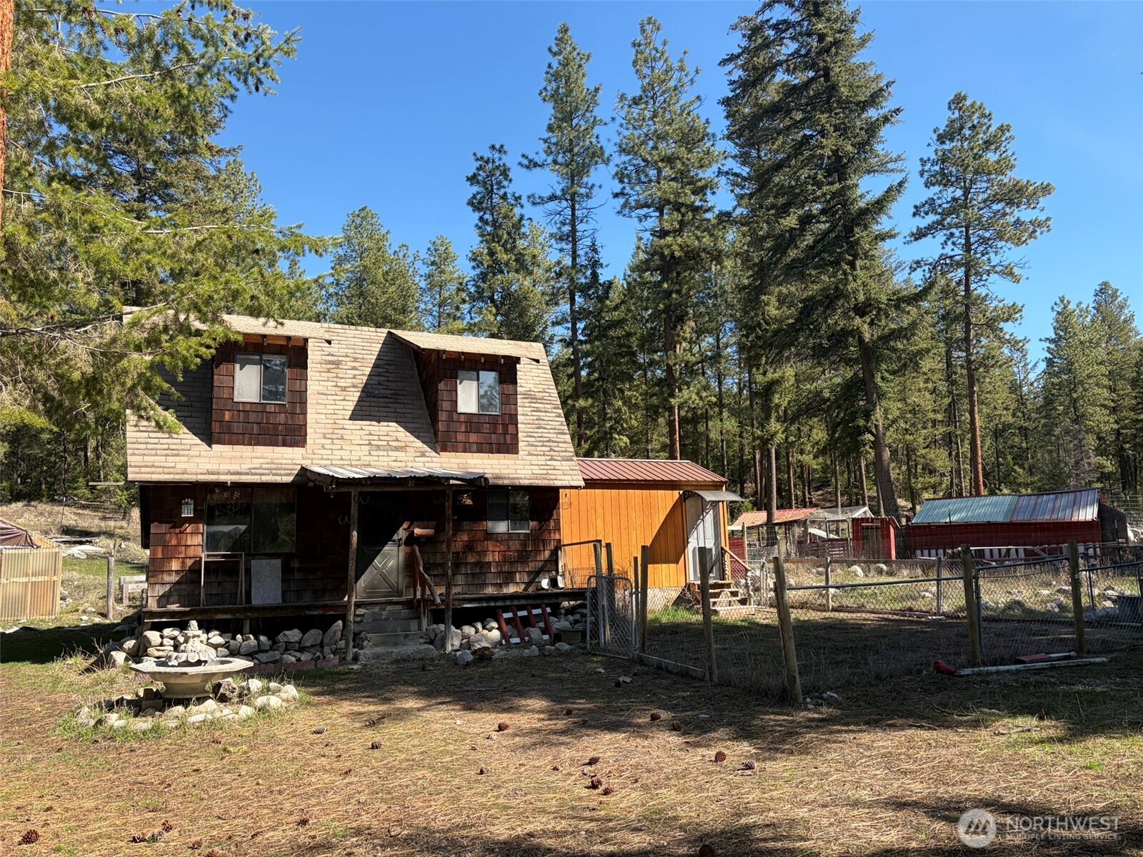 13 Rope And Saddle Lane Tonasket, WA 98855 - Photo 1 of 28 a front view of a house with garden