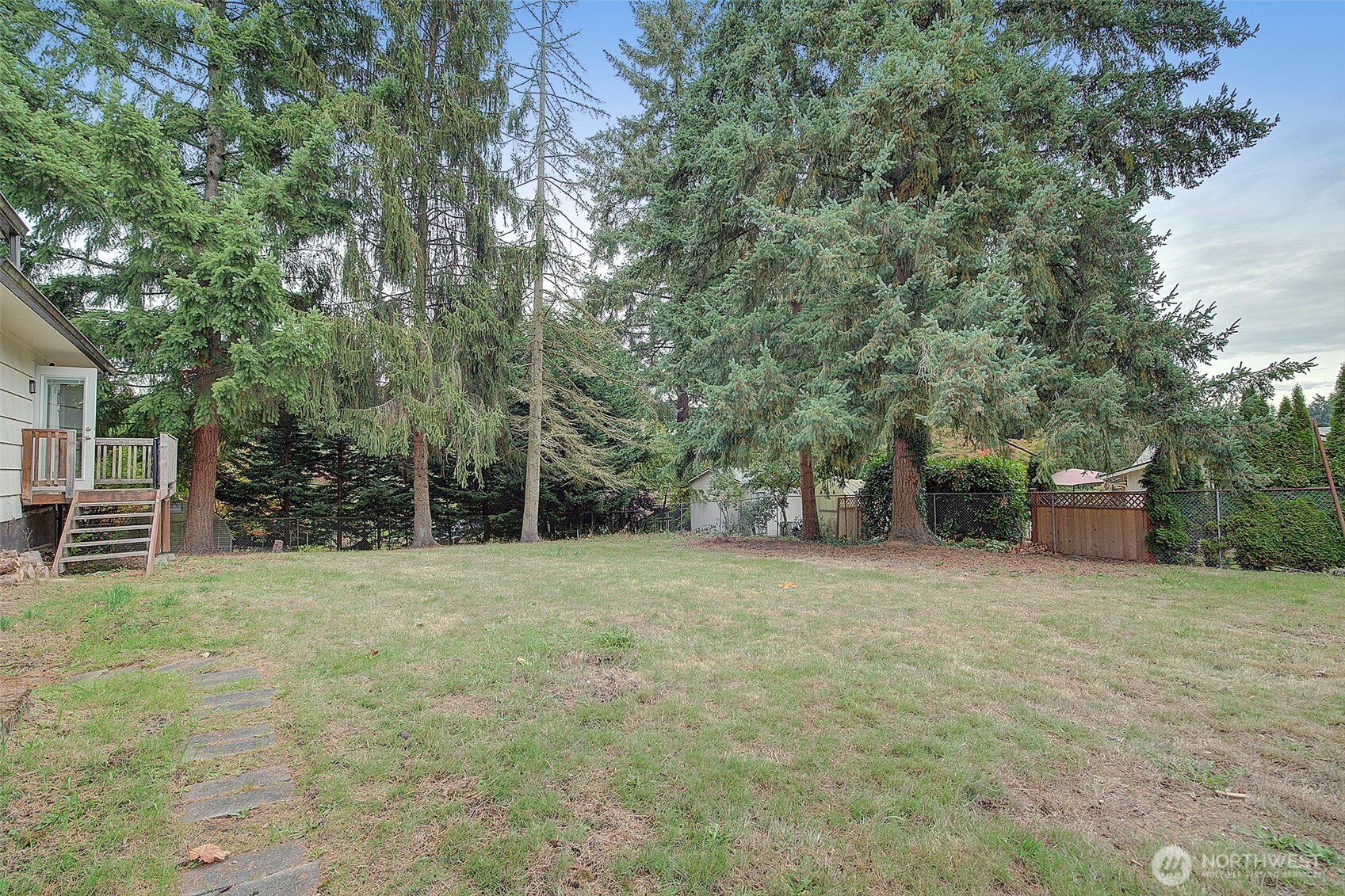 35814 11th Avenue Southwest Federal Way, WA 98023 - Photo 22 of 24 a backyard of a house with large trees and parked