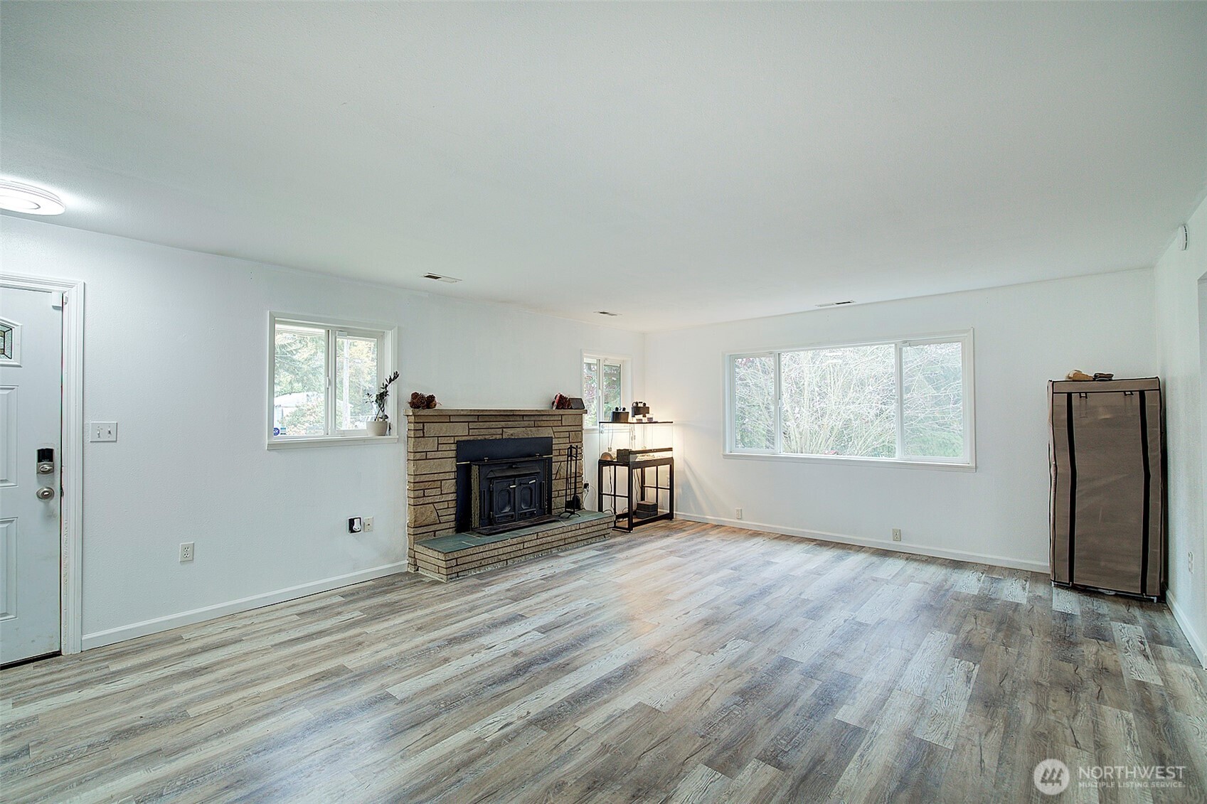 35814 11th Avenue Southwest Federal Way, WA 98023 - Photo 6 of 24 a view of empty room with a fireplace and wooden floor
