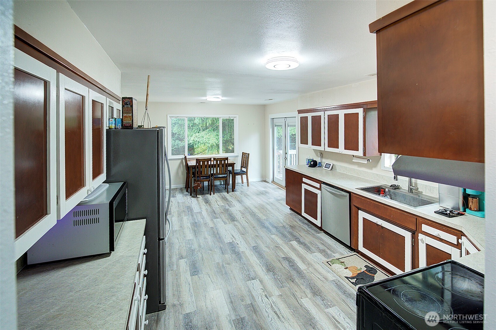 35814 11th Avenue Southwest Federal Way, WA 98023 - Photo 10 of 24 a kitchen with stainless steel appliances granite countertop a refrigerator a stove top oven a sink dishwasher and wooden cabinets with wooden floor