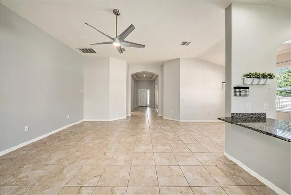 a large kitchen with granite countertop a sink and a stove