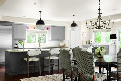 a dining table chairs and a chandelier