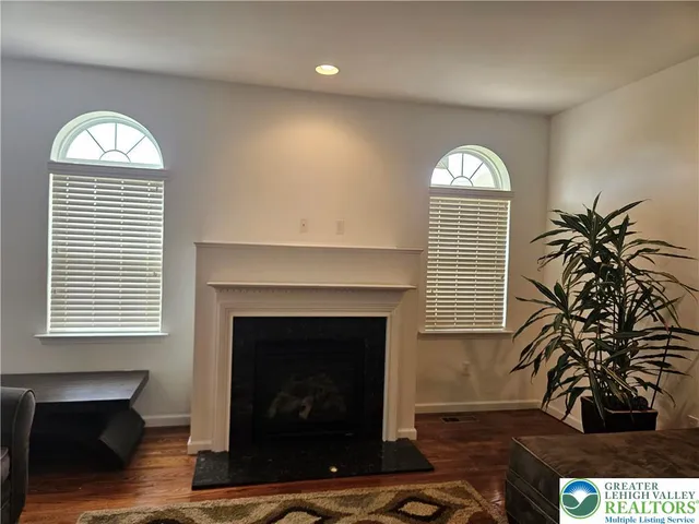 a view of a livingroom with a fireplace and window