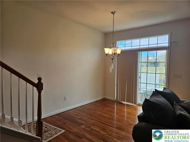 a view of a livingroom with wooden floor and a window