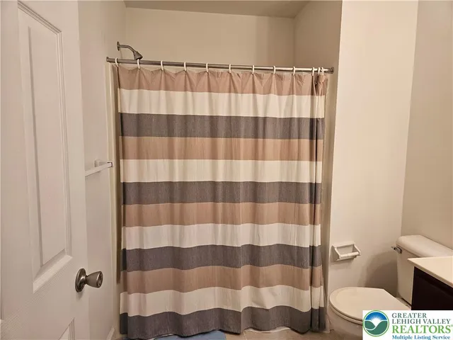 a bathroom with a shower curtain