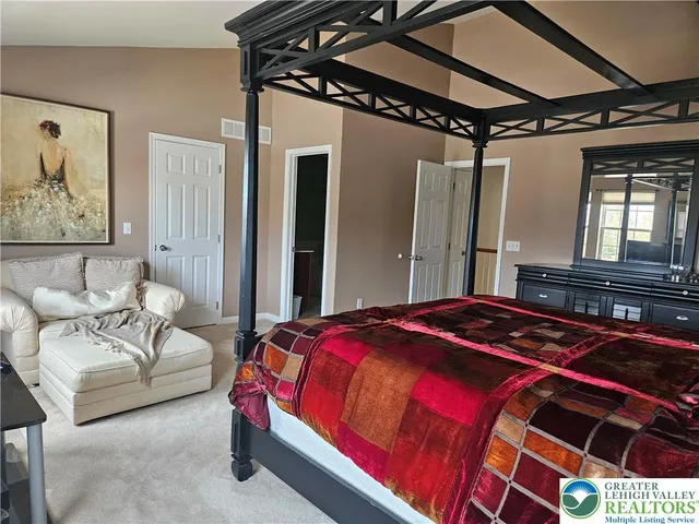 a bedroom with bed and window