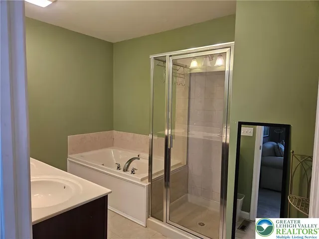 a bathroom with a tub and a shower