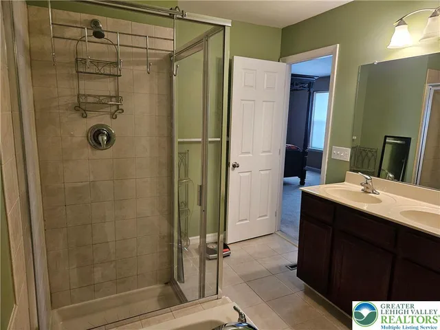 a bathroom with a shower and a sink