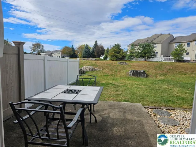 a view of a backyard with sitting area