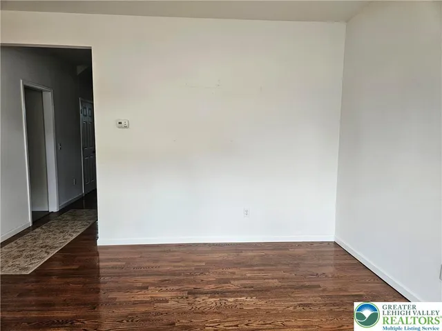 a view of an empty room and wooden floor