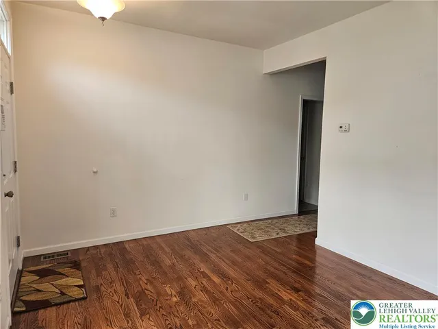 an empty room with wooden floor