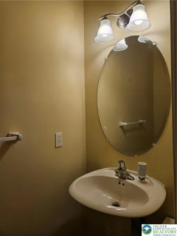 a bathroom with a sink and mirror