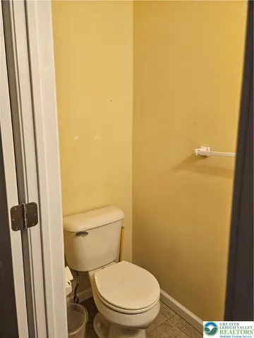 a white toilet sitting next to a small sink