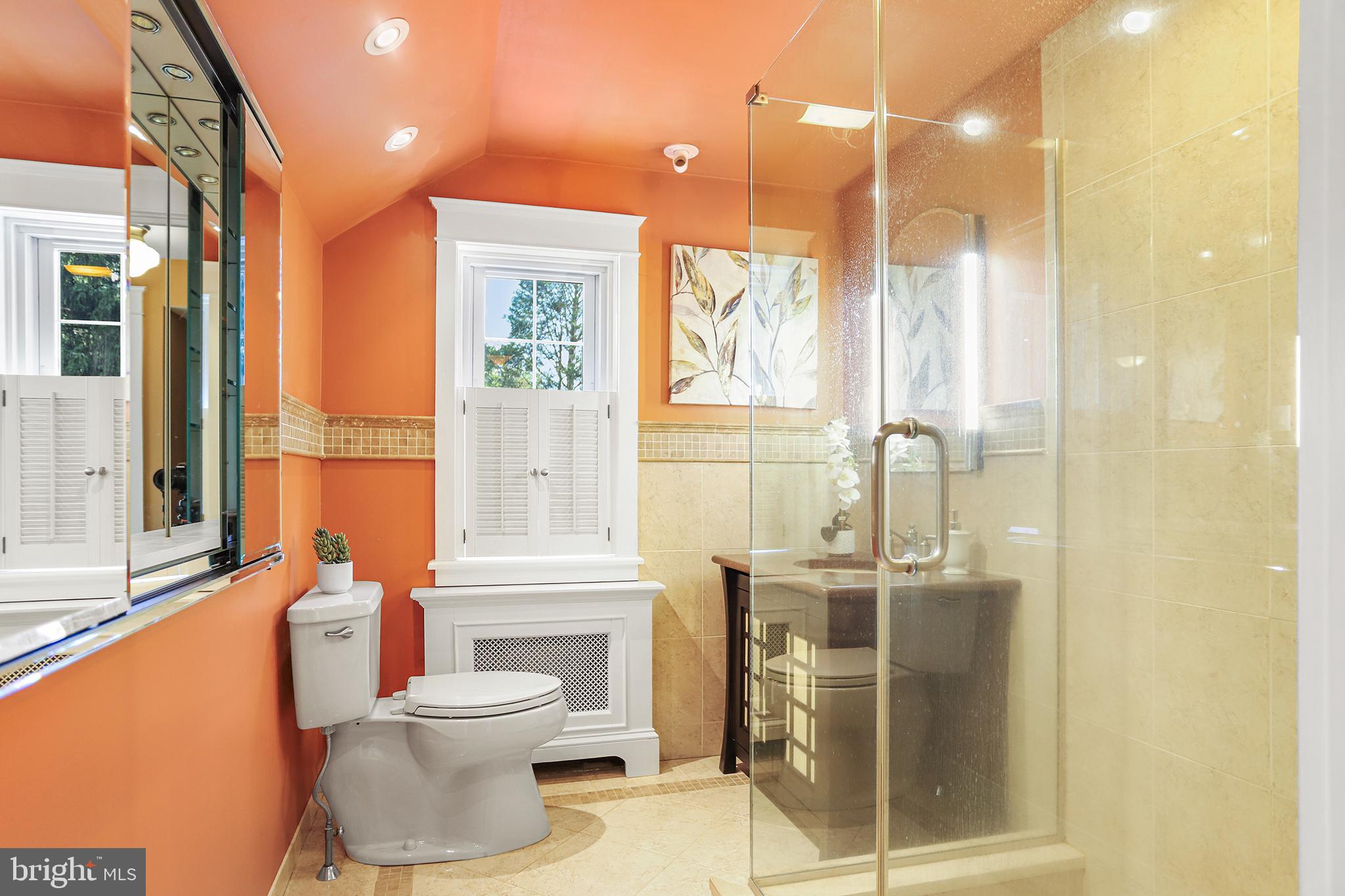 38 Green Valley Road Wallingford, PA 19086 - Photo 25 of 33 a bathroom with a toilet a sink and mirror