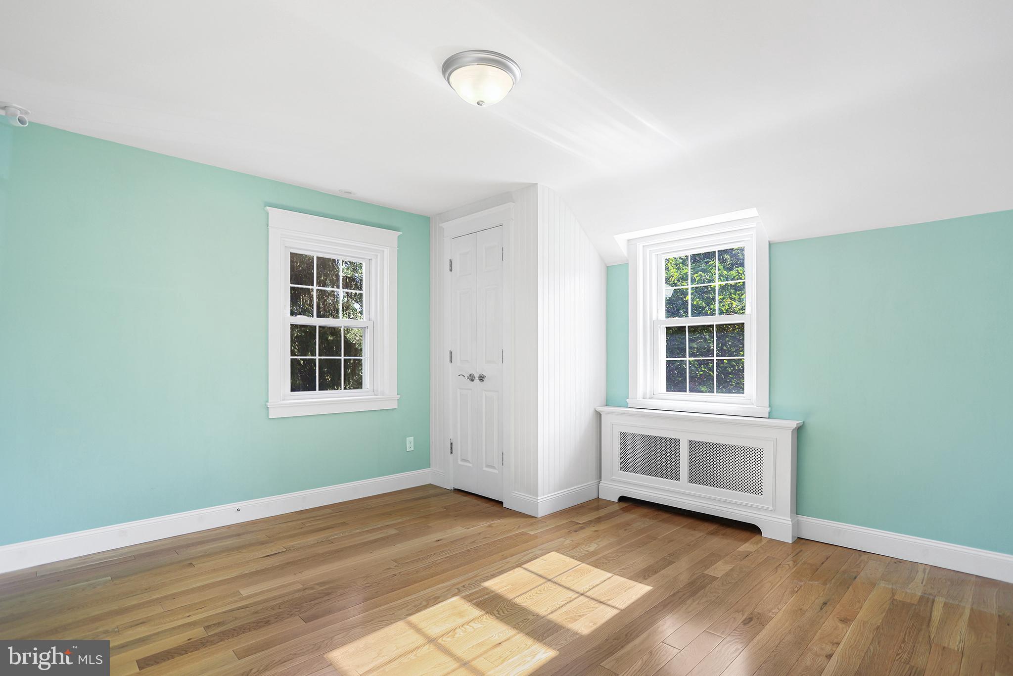 38 Green Valley Road Wallingford, PA 19086 - Photo 26 of 33 an empty room with wooden floor and windows