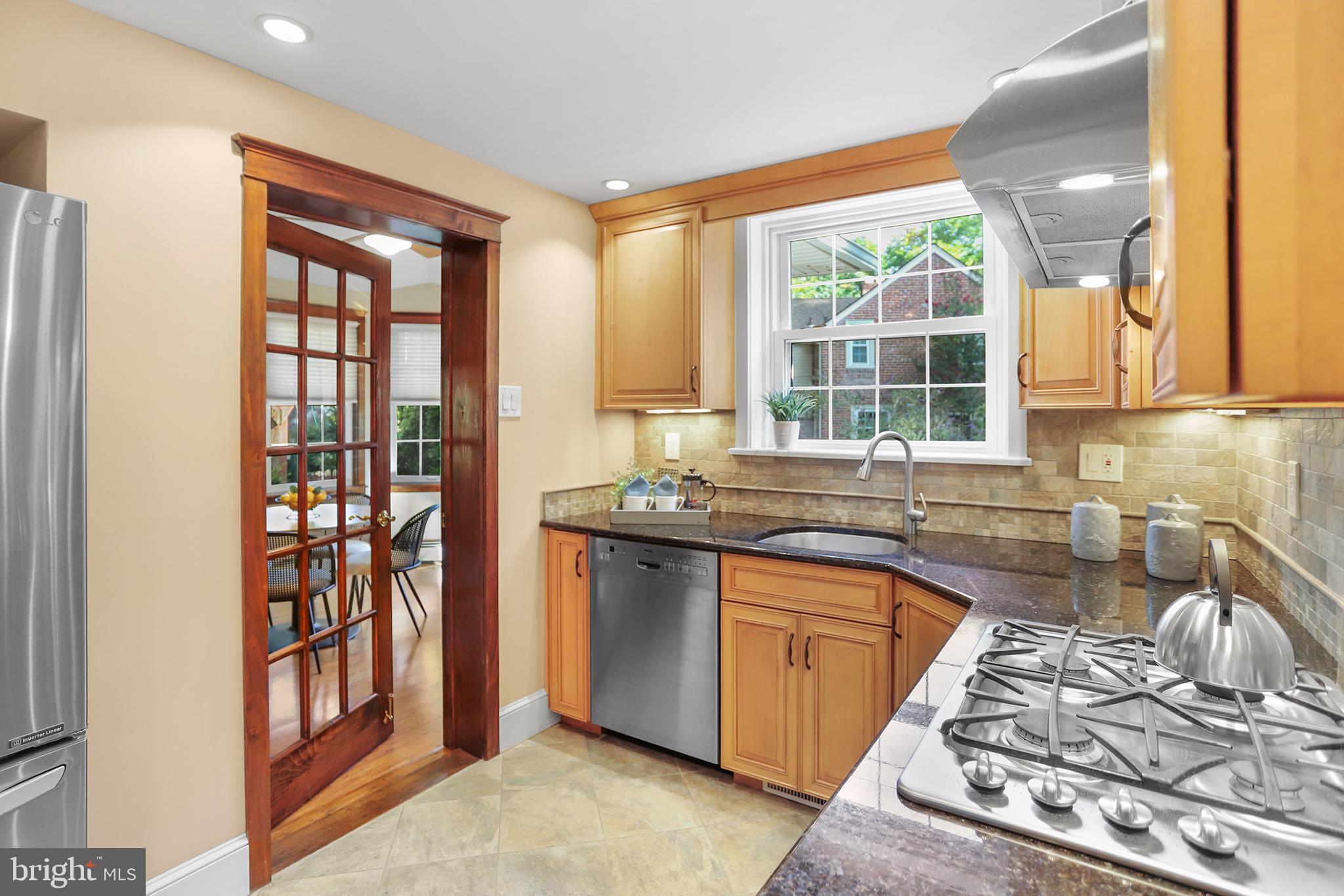 38 Green Valley Road Wallingford, PA 19086 - Photo 9 of 33 a kitchen with stainless steel appliances granite countertop a sink stove and granite counter top