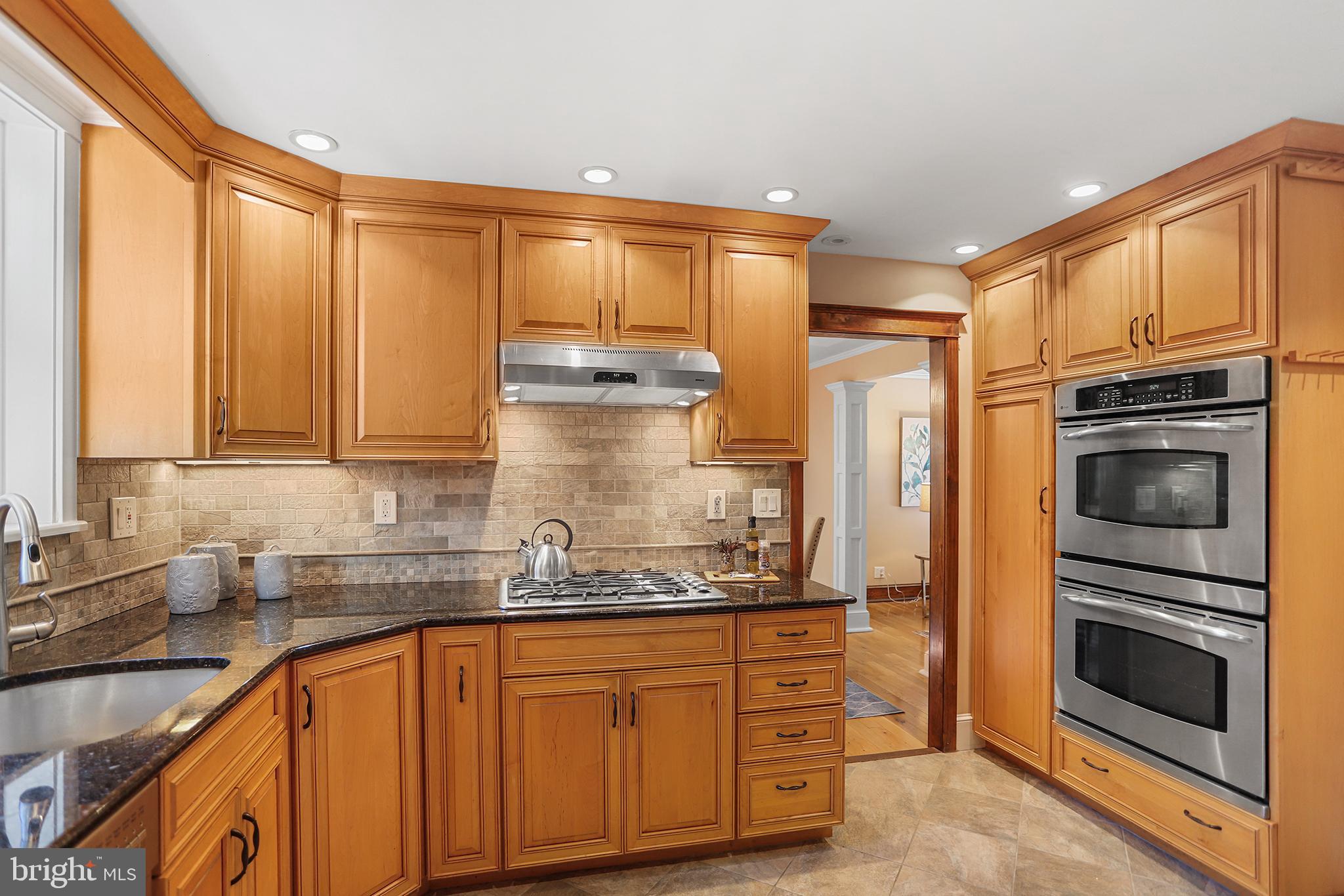 38 Green Valley Road Wallingford, PA 19086 - Photo 10 of 33 a kitchen with stainless steel appliances granite countertop a refrigerator and cabinets