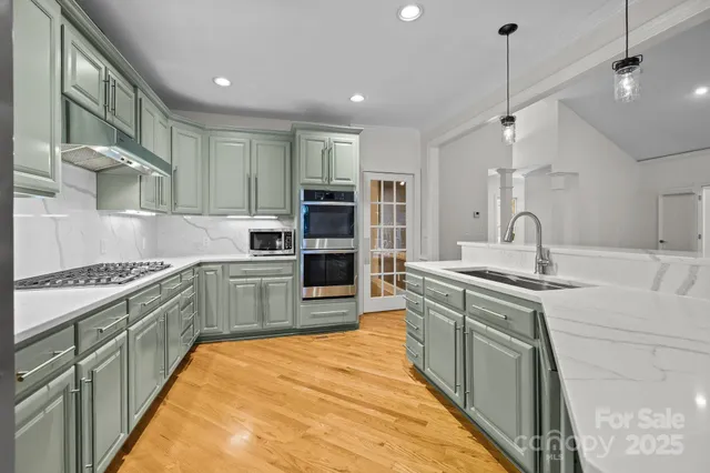 a kitchen with kitchen island a sink stove and refrigerator