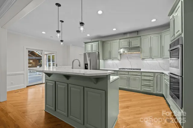 a kitchen with counter top space sink and refrigerator