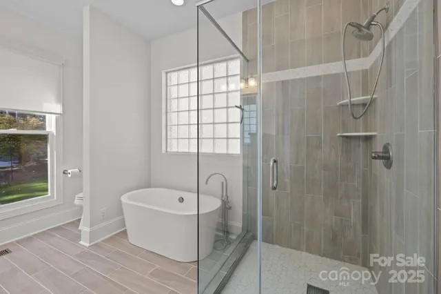 a bathroom with a bathtub and shower