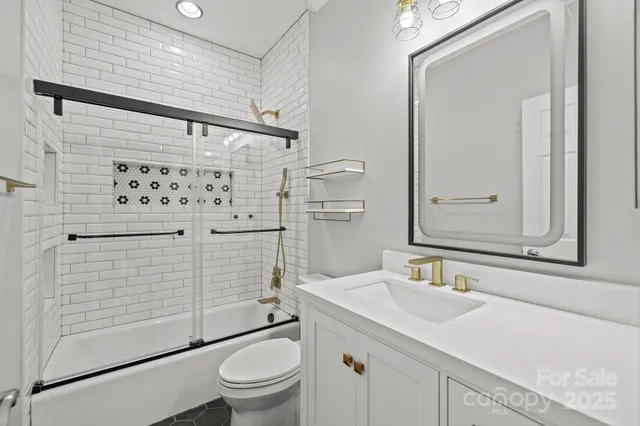 a bathroom with a sink toilet and shower