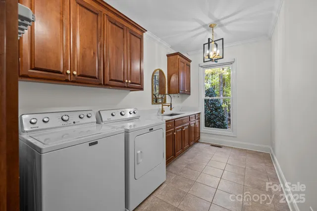 a kitchen with a sink cabinets and window
