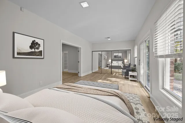 a bedroom with a bed and a large window with outer view