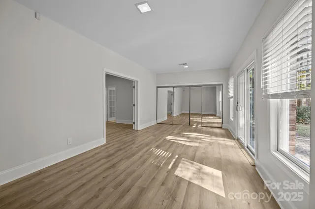 a view of a room with wooden floor and windows